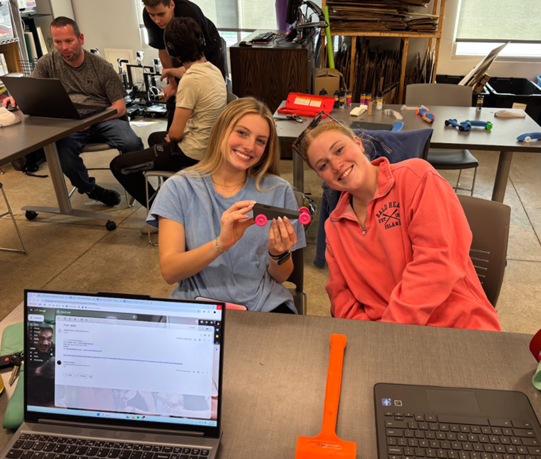AMx participants presenting a small wheeled prototype during a project session